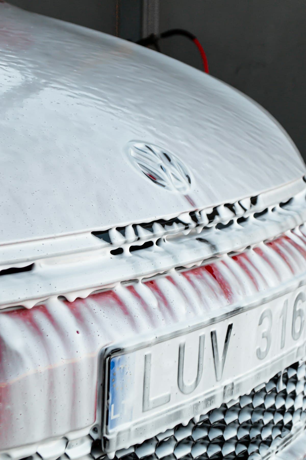 Close-up of white car front end after detail